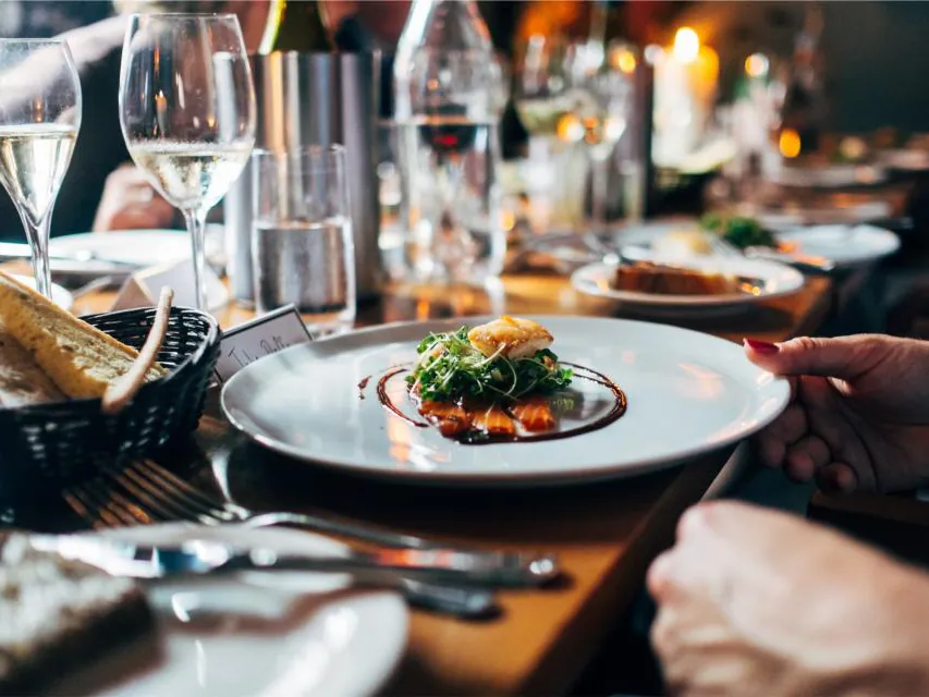 A plated dish on a busy restaurant table